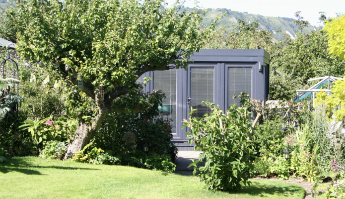 Cute QCB garden studio summerhouse at the end of a garden 